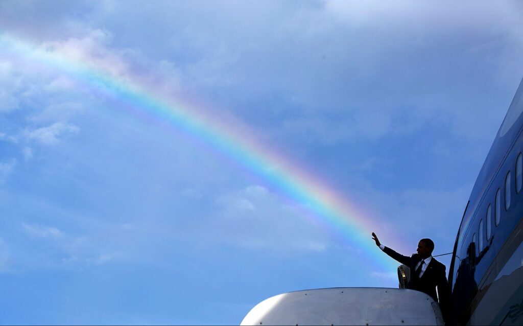 Pete Souza: Barack Obama’s wave aligns with a rainbow as he boards Air Force One